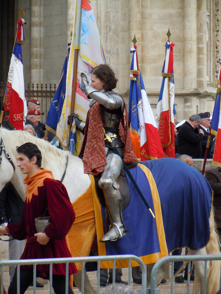 The lucky young woman chosen to portray Joan in the 2013 Orléans festival waves at the crowd; photo by the author.
